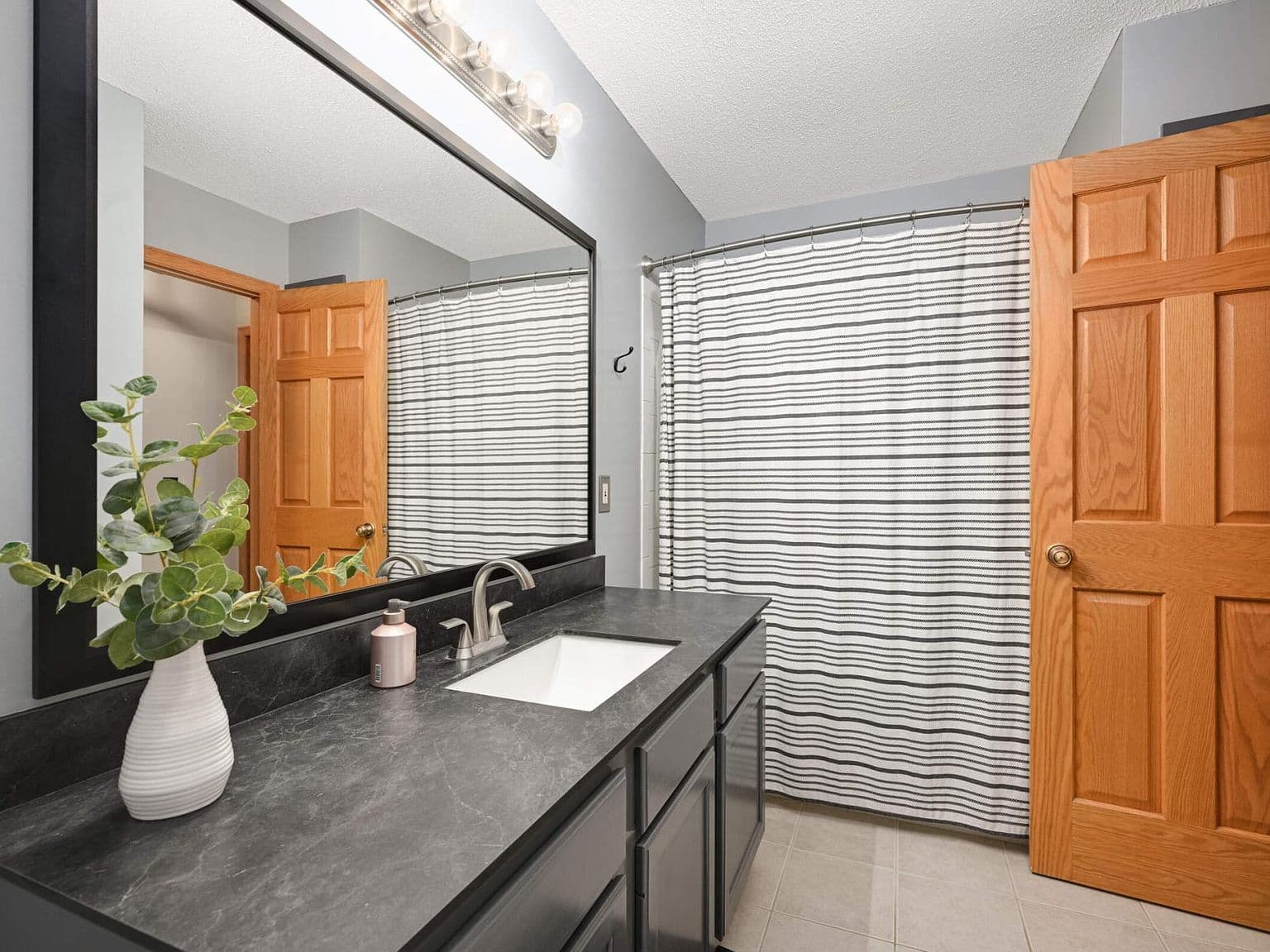 Dated bathroom countertop and mirror